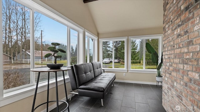 sunroom / solarium featuring lofted ceiling