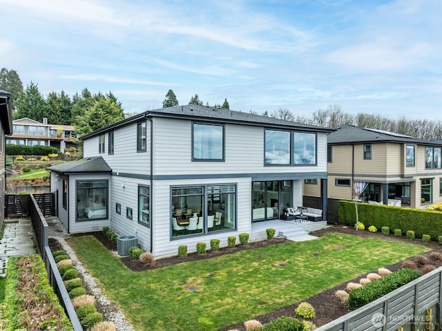 rear view of property featuring a patio area, a lawn, cooling unit, and fence