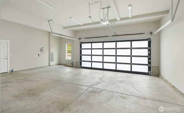 garage featuring baseboards, electric panel, and a garage door opener