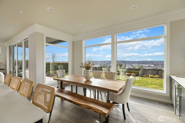 sunroom featuring visible vents and a wealth of natural light