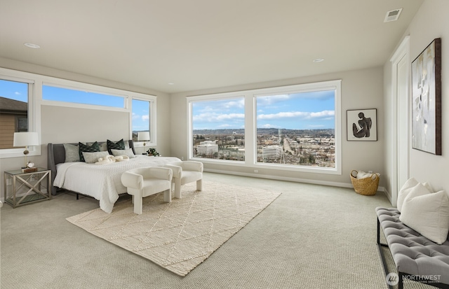 carpeted bedroom featuring baseboards and visible vents