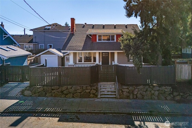 view of front facade featuring a fenced front yard and a porch