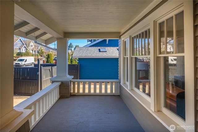 balcony with covered porch and a sunroom