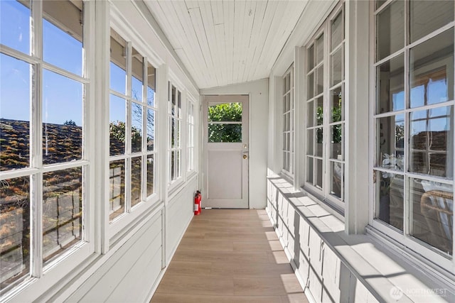 unfurnished sunroom featuring wooden ceiling and vaulted ceiling