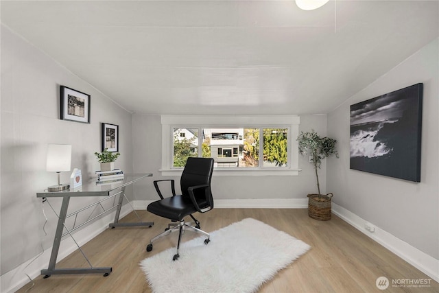 office with lofted ceiling, wood finished floors, and baseboards