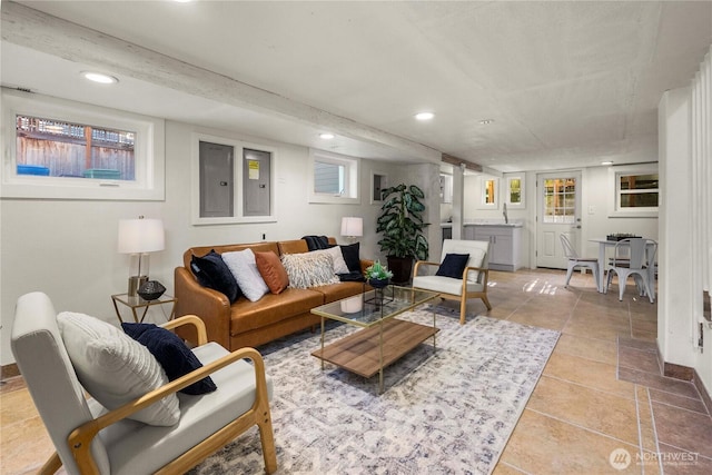 living area with electric panel and recessed lighting