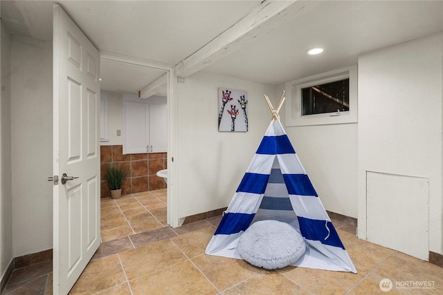 recreation room with baseboards, beamed ceiling, and recessed lighting