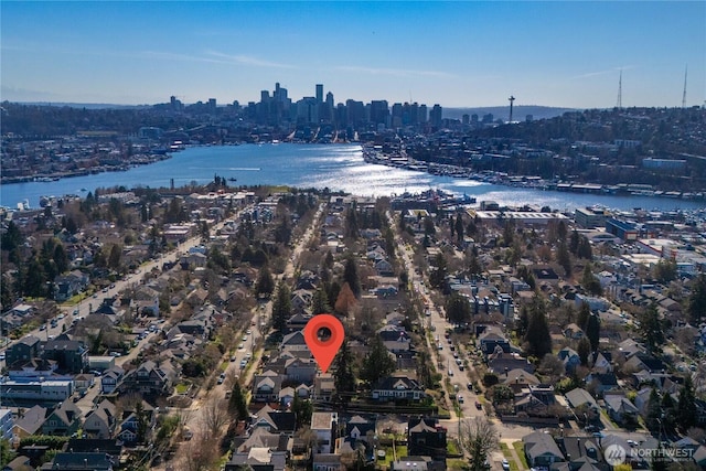 birds eye view of property featuring a water view and a city view