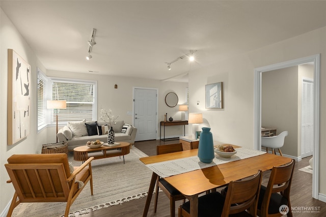 dining area with dark wood-style floors and baseboards