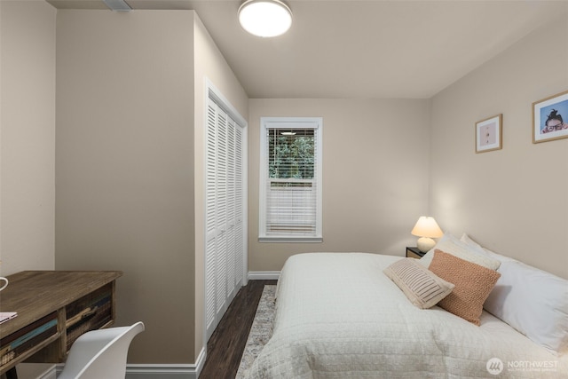 bedroom featuring wood finished floors and baseboards