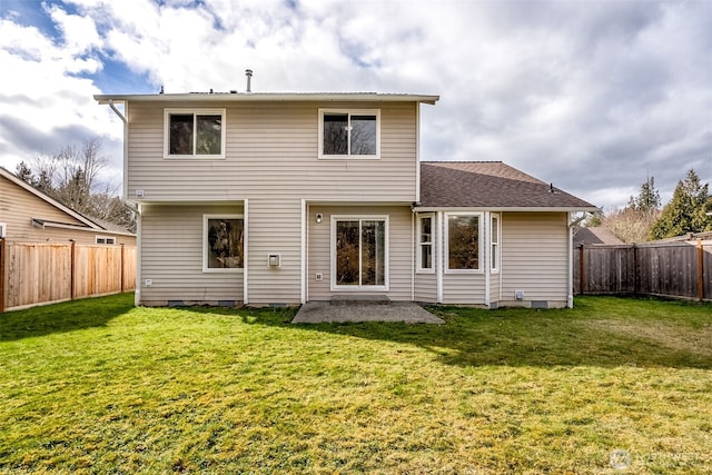 rear view of property with crawl space, a fenced backyard, and a lawn