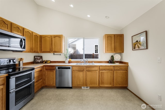 kitchen with recessed lighting, stainless steel appliances, a sink, visible vents, and brown cabinets