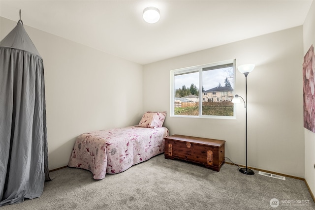 carpeted bedroom featuring visible vents