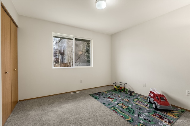 game room with carpet, visible vents, and baseboards