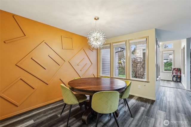 dining area with baseboards, dark wood-type flooring, and an inviting chandelier