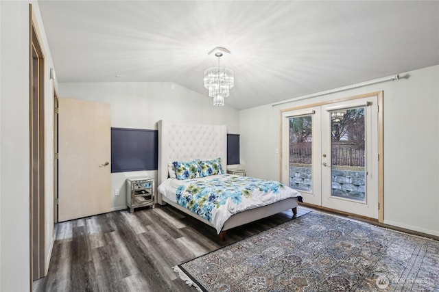 bedroom featuring lofted ceiling, wood finished floors, access to outside, french doors, and a notable chandelier