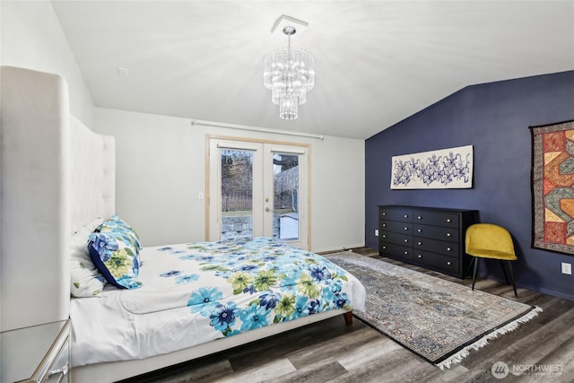 bedroom featuring a chandelier, wood finished floors, vaulted ceiling, access to outside, and french doors