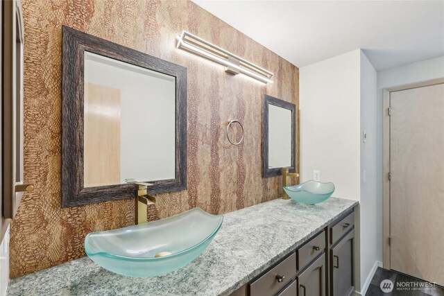 bathroom featuring double vanity and a sink