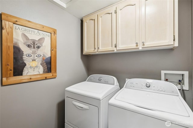 washroom featuring cabinet space and washing machine and dryer