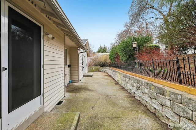 view of side of property featuring fence and a patio