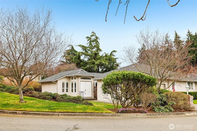 ranch-style home with a front lawn