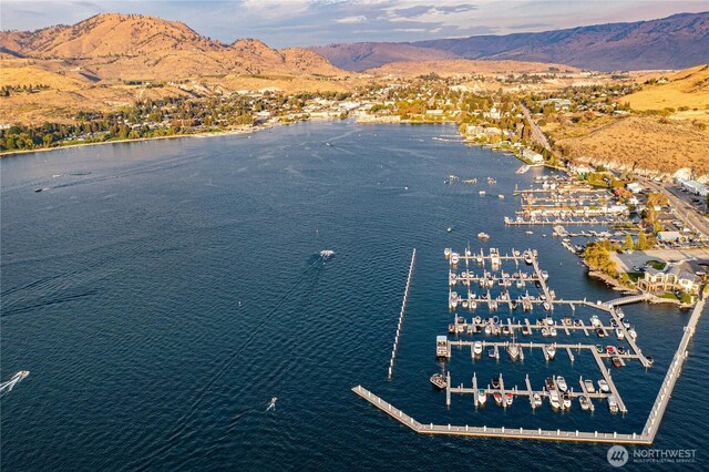 birds eye view of property with a water and mountain view