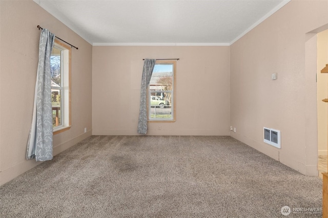 carpeted empty room with ornamental molding and visible vents