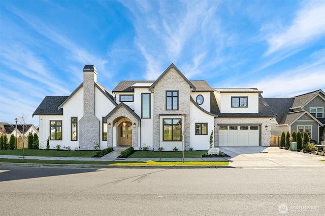 view of front of house featuring a front lawn, stone siding, concrete driveway, a garage, and a chimney