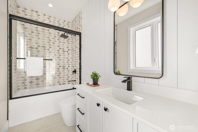 full bath with vanity, toilet, tile patterned flooring, and shower / bath combination with glass door