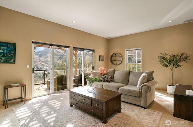 living area with light colored carpet and a healthy amount of sunlight