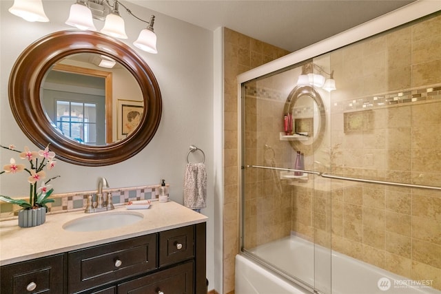 full bathroom featuring enclosed tub / shower combo and vanity