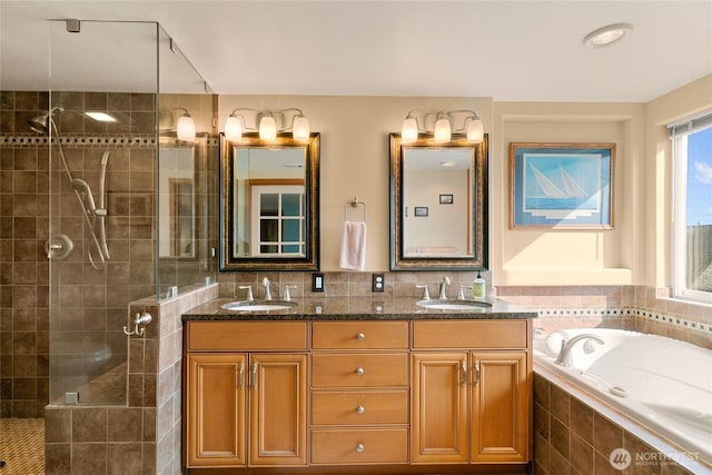 full bathroom with a garden tub, a sink, a tile shower, and double vanity