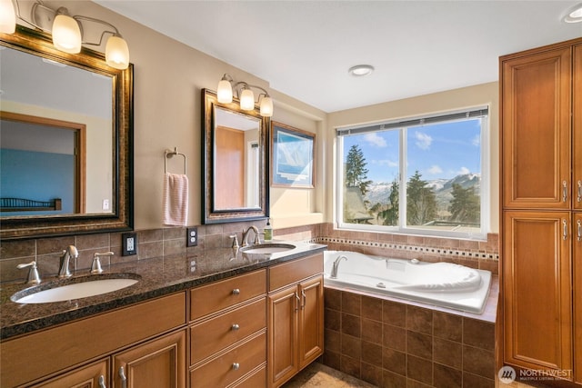 full bathroom with a jetted tub, double vanity, decorative backsplash, and a sink