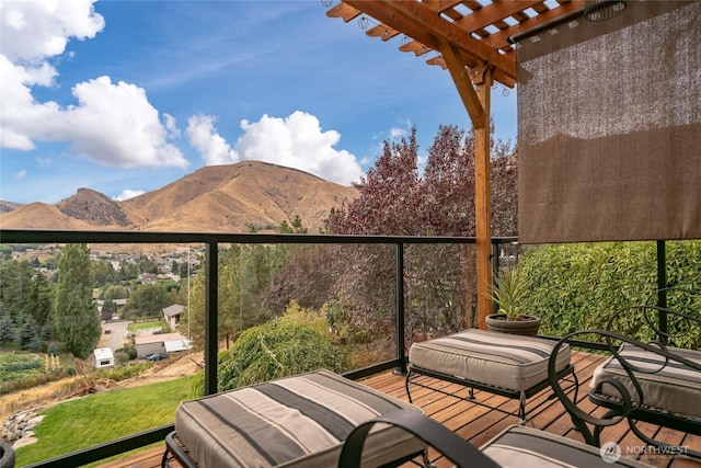 balcony featuring a mountain view and a pergola