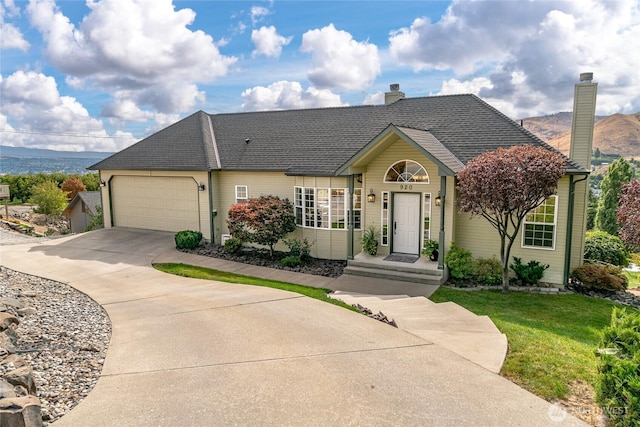 single story home with driveway, an attached garage, a front lawn, and a shingled roof