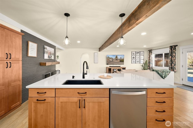 kitchen featuring light wood-type flooring, beam ceiling, dishwasher, and a sink