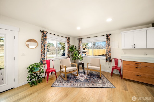 sitting room featuring light wood finished floors, recessed lighting, and baseboards