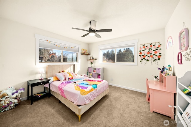 carpeted bedroom with ceiling fan and baseboards