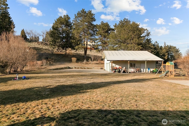 view of yard featuring a playground and an outdoor structure