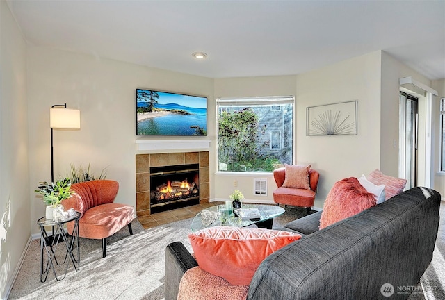 living room featuring a fireplace and baseboards