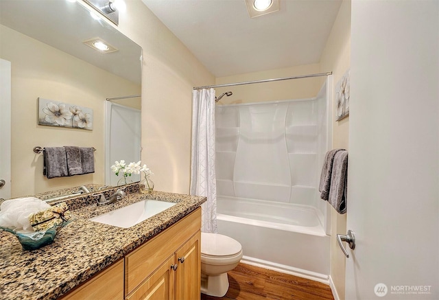 bathroom with toilet, vanity, shower / tub combo with curtain, and wood finished floors