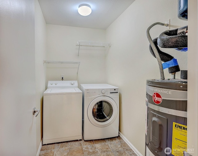 laundry area featuring laundry area, stone finish flooring, baseboards, and washer and dryer