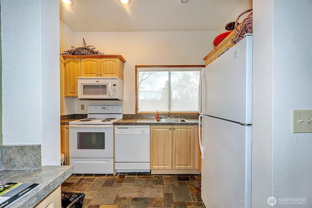 kitchen with recessed lighting, white appliances, a sink, light brown cabinetry, and stone finish flooring