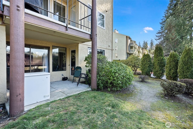 view of yard with a patio and a balcony