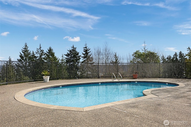 view of pool featuring a patio area, fence, and a fenced in pool