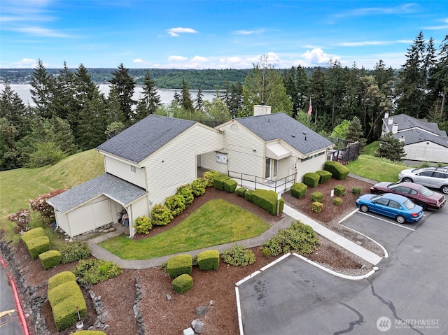 aerial view with a water view and a view of trees