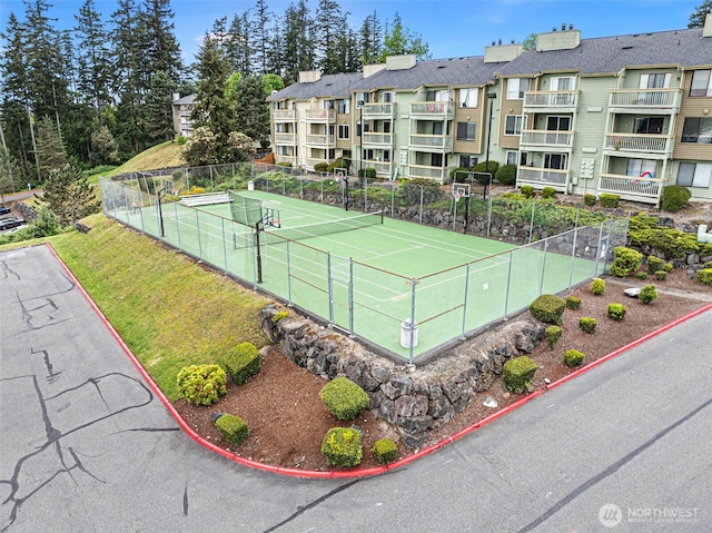 view of sport court featuring fence