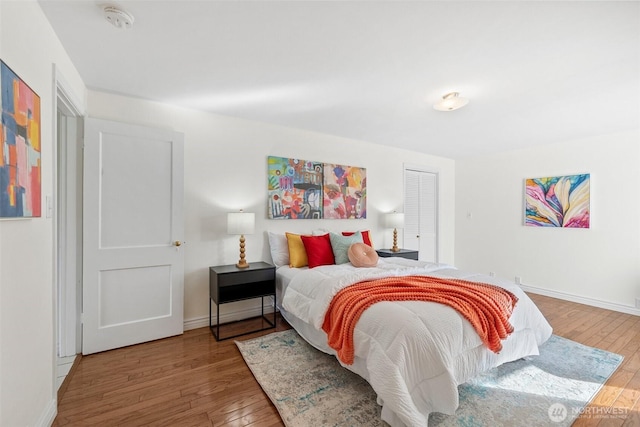 bedroom featuring baseboards and hardwood / wood-style flooring