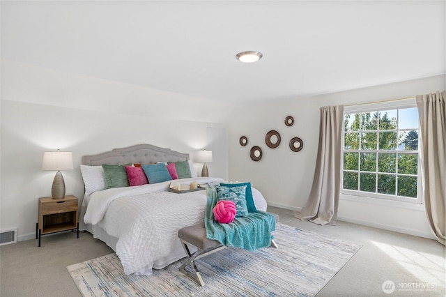 bedroom with carpet, visible vents, and baseboards