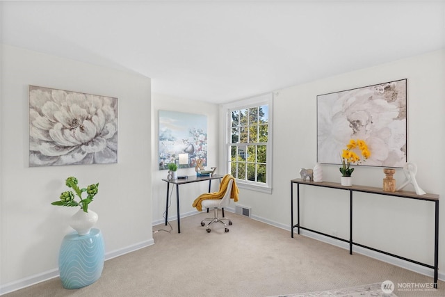 carpeted office space with visible vents and baseboards